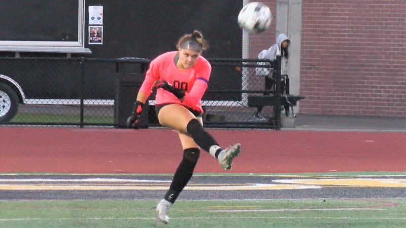 The Union-Endicott goalie punts a ball away during a high school soccer game.