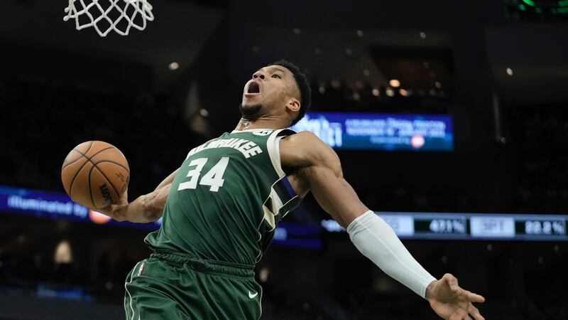 Milwaukee Bucks' Giannis Antetokounmpo dunks during the first half of an NBA basketball game...