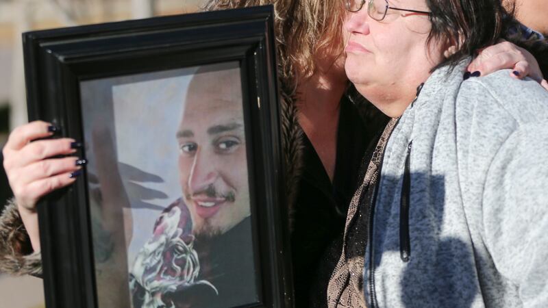 FILE - Lisa Finch, the mother of Andrew Finch, hugs Lorrie Hernandez, who is holding a...
