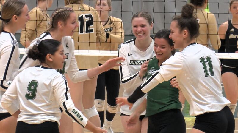 The Binghamton volleyball team celebrates after a point during their win over Bryant.