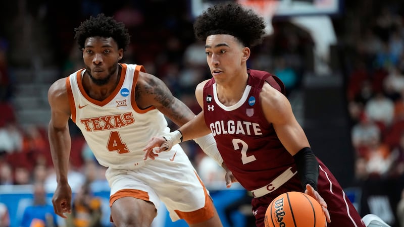 Colgate guard Braeden Smith (2) drives past Texas guard Tyrese Hunter (4) in the first half of...