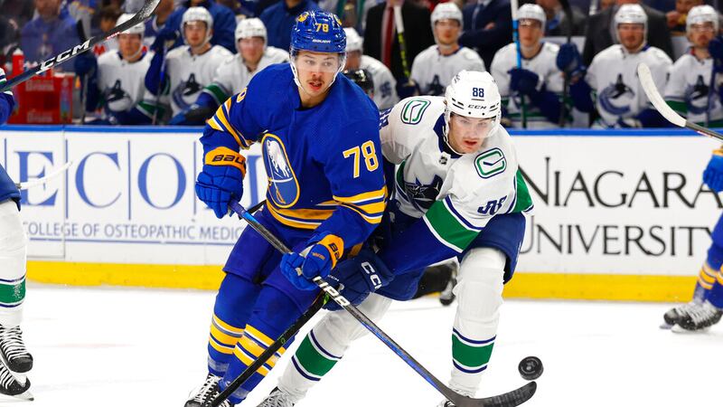 Buffalo Sabres defenseman Jacob Bryson (78) and Vancouver Canucks center Nils Aman (88) battle...