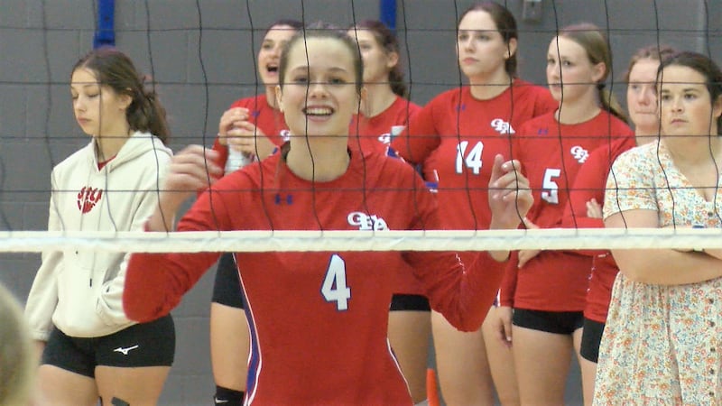 Owego's Emma Bryant (4) celebrates after a score in a high school volleyball game.