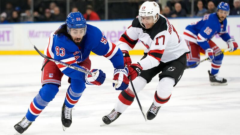 New York Rangers center Mika Zibanejad (93) and New Jersey Devils center Yegor Sharangovich...