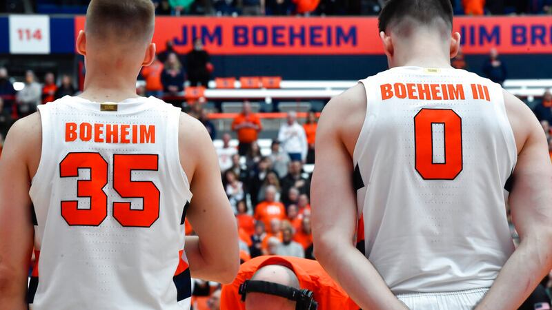 Syracuse guard Buddy Boeheim (35) and forward Jimmy Boeheim (0) stand as the national anthem...