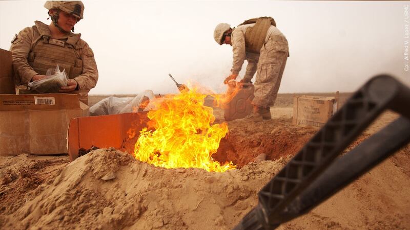 PHOTO: U.S. Marines dispose of trash in a burn pit, Photo Date: 2012