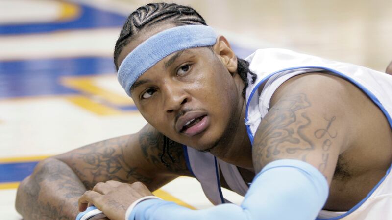 FILE - Denver Nuggets forward Carmelo Anthony looks up from the floor after getting called for...
